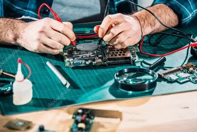 Technician working on industrial dimmer modules at an electronics repair bench