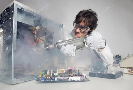 Technician performing routine maintenance on office desktop computers